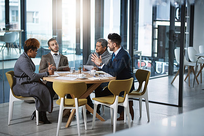 Buy stock photo Full length shot of a group of businesspeople sitting in the boardroom during a meeting