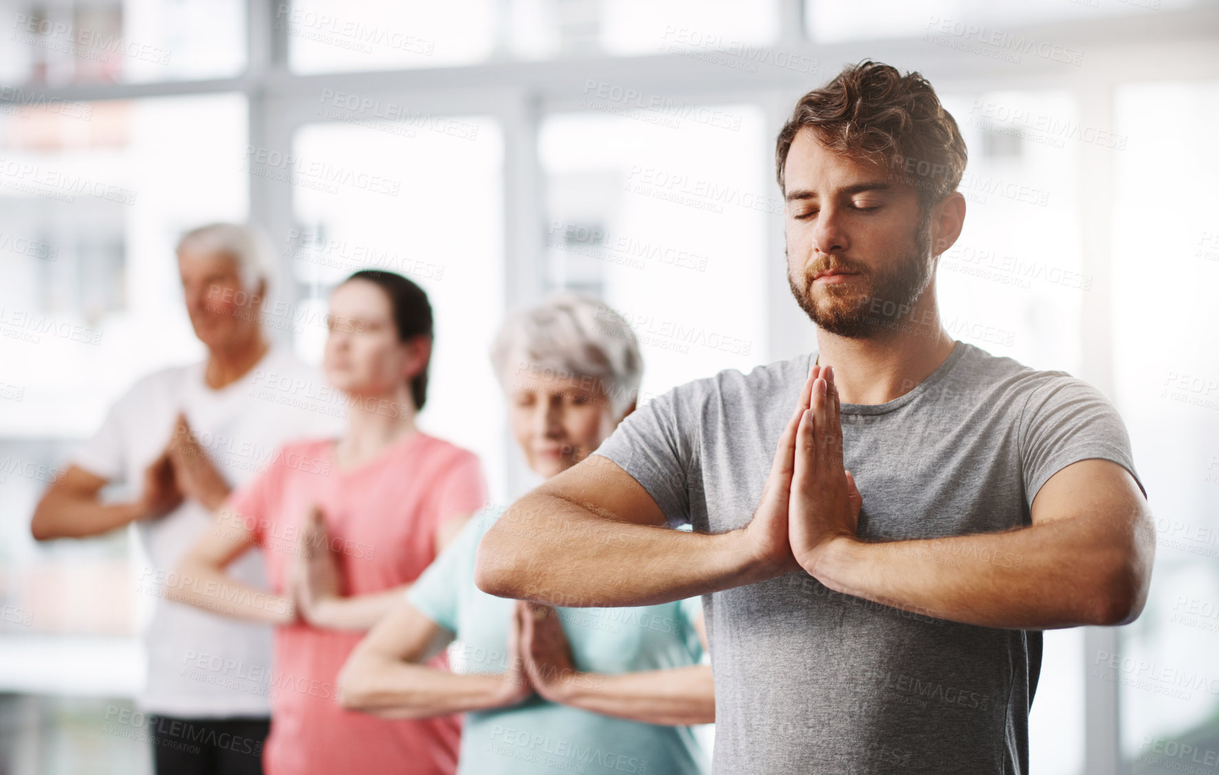 Buy stock photo Cropped shot of a group of people meditating while practicing yoga