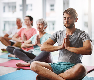 Buy stock photo Cropped shot of a group of people meditating while practicing yoga