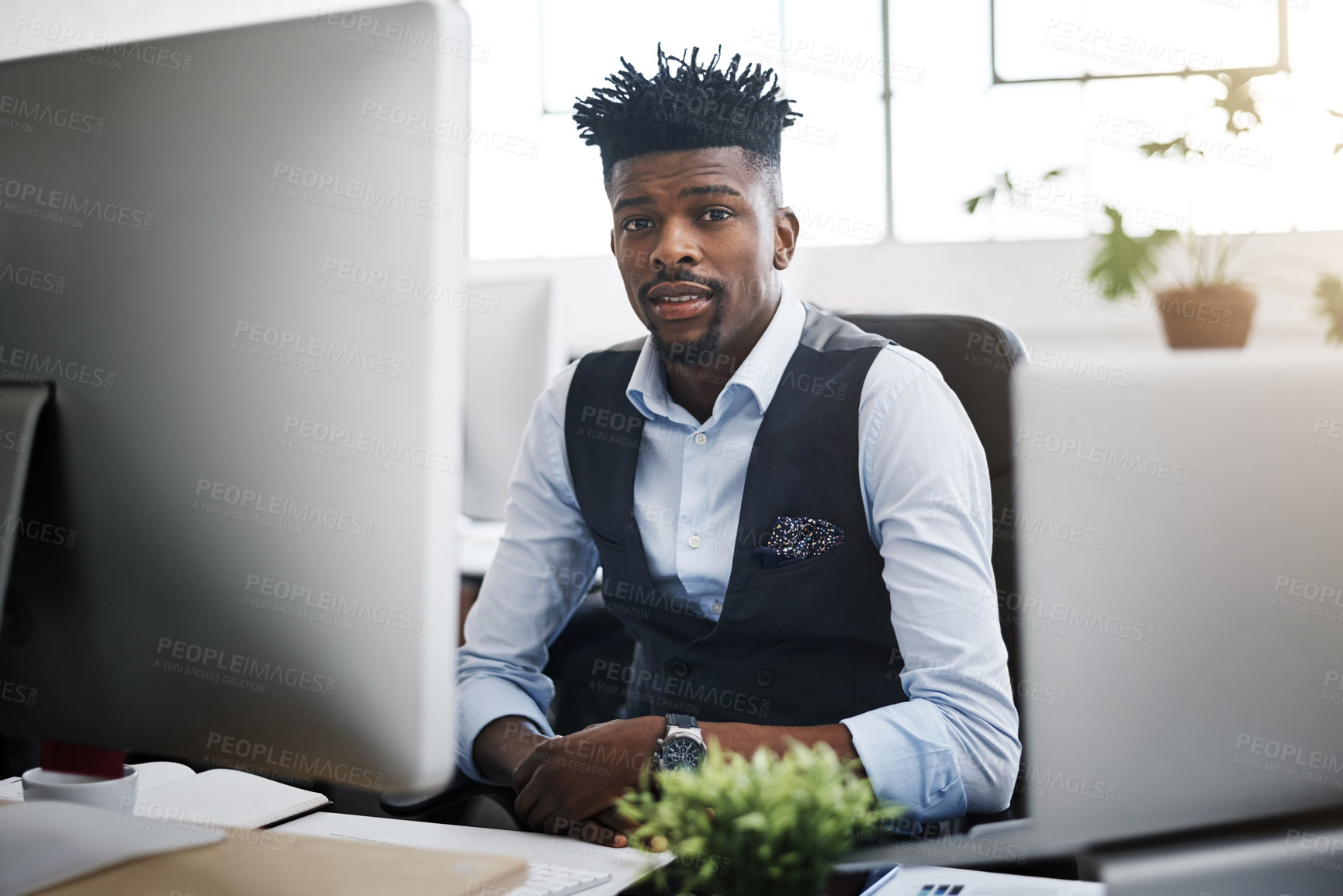 Buy stock photo Portrait of a young businessman at his desk in a modern office