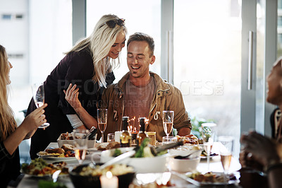 Buy stock photo Shot of a young man celebrating his birthday with his friends