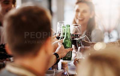 Buy stock photo Shot of a group of young friends making a toast at a dinner party