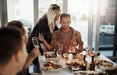 Buy stock photo Shot of a young man celebrating his birthday with his friends