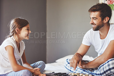 Buy stock photo Cropped shot of a young father playing a board game with his adorable little daughter at home