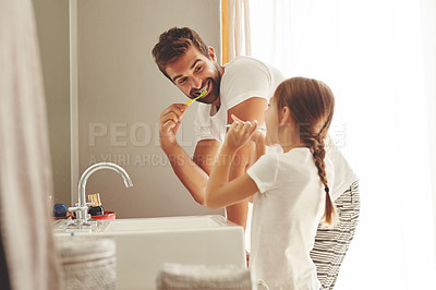 Buy stock photo Dental care, father with daughter brush their teeth and in bathroom of their home. Oral hygiene routine, parent with child use toothbrush for health and wellness mouth protection in the morning