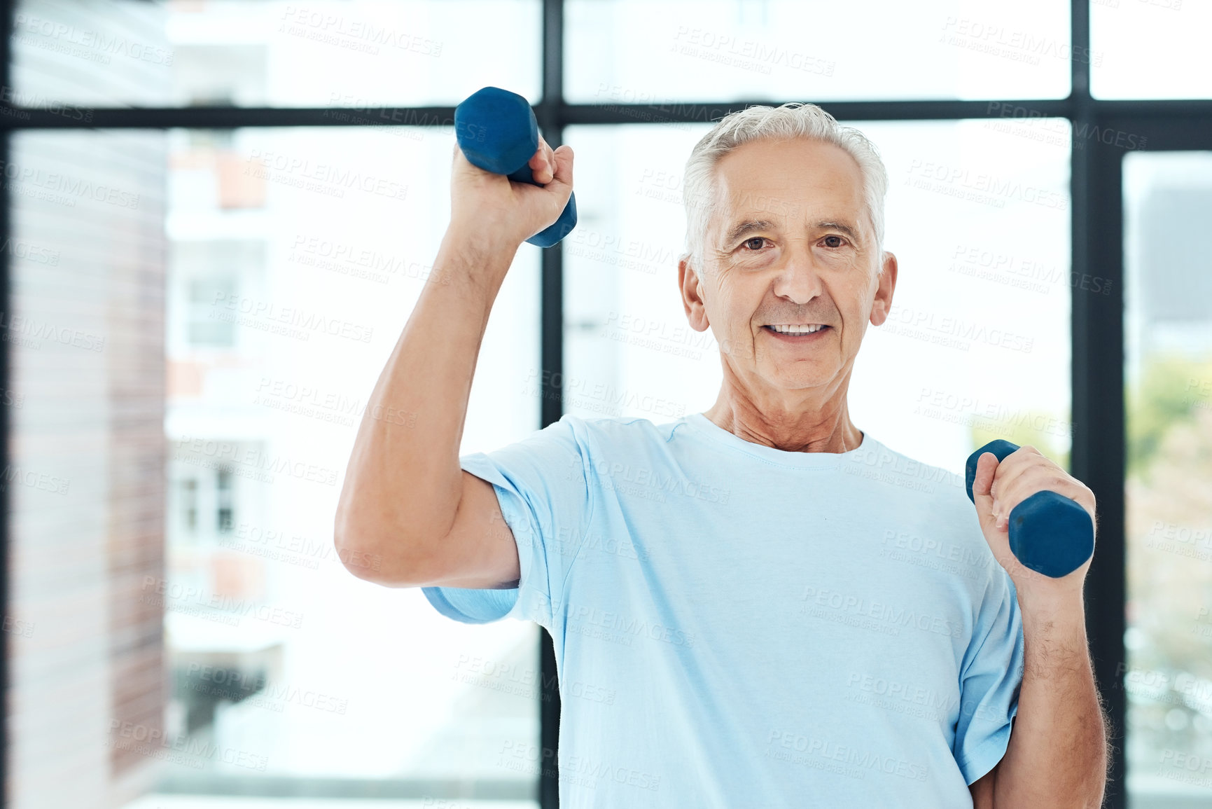 Buy stock photo Shot of a senior man working out with dumbbells