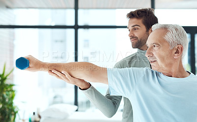 Buy stock photo Shot of a friendly physiotherapist helping his senior patient work out with weights