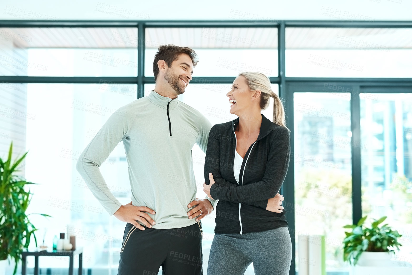 Buy stock photo Cropped shot of two people standing together in a fitness center