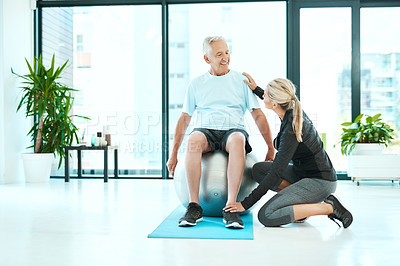 Buy stock photo Shot of a senior man working out in a rehabilitation center