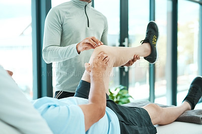 Buy stock photo Shot of a senior man consulting with his physiotherapist