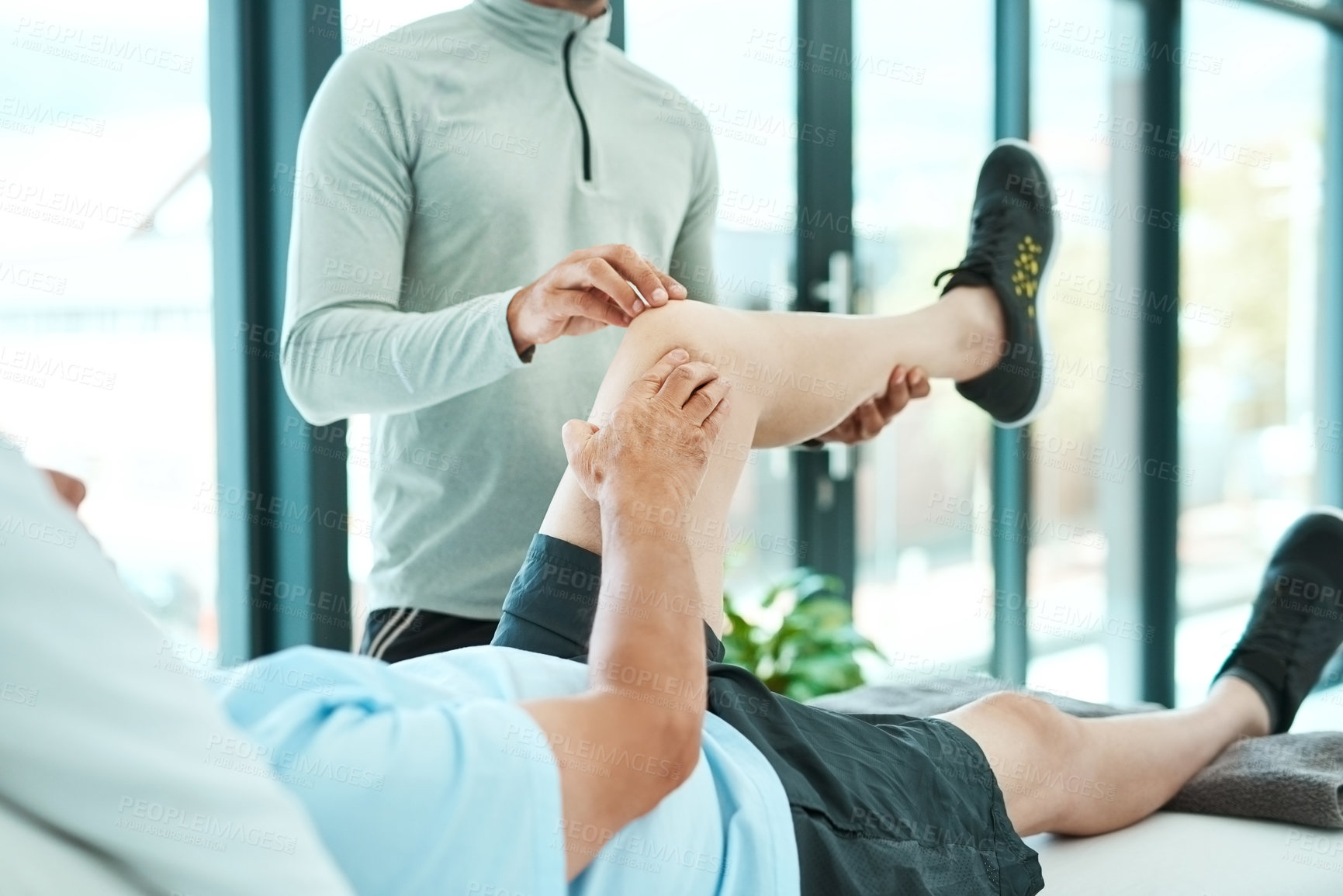 Buy stock photo Shot of a senior man consulting with his physiotherapist
