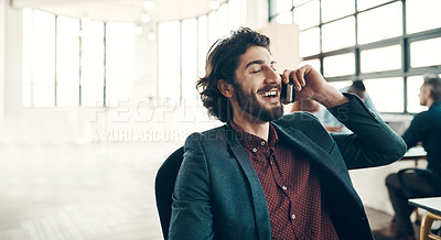Buy stock photo Shot of a young businessman using a cellphone in a modern office