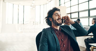 Buy stock photo Shot of a young businessman using a cellphone in a modern office