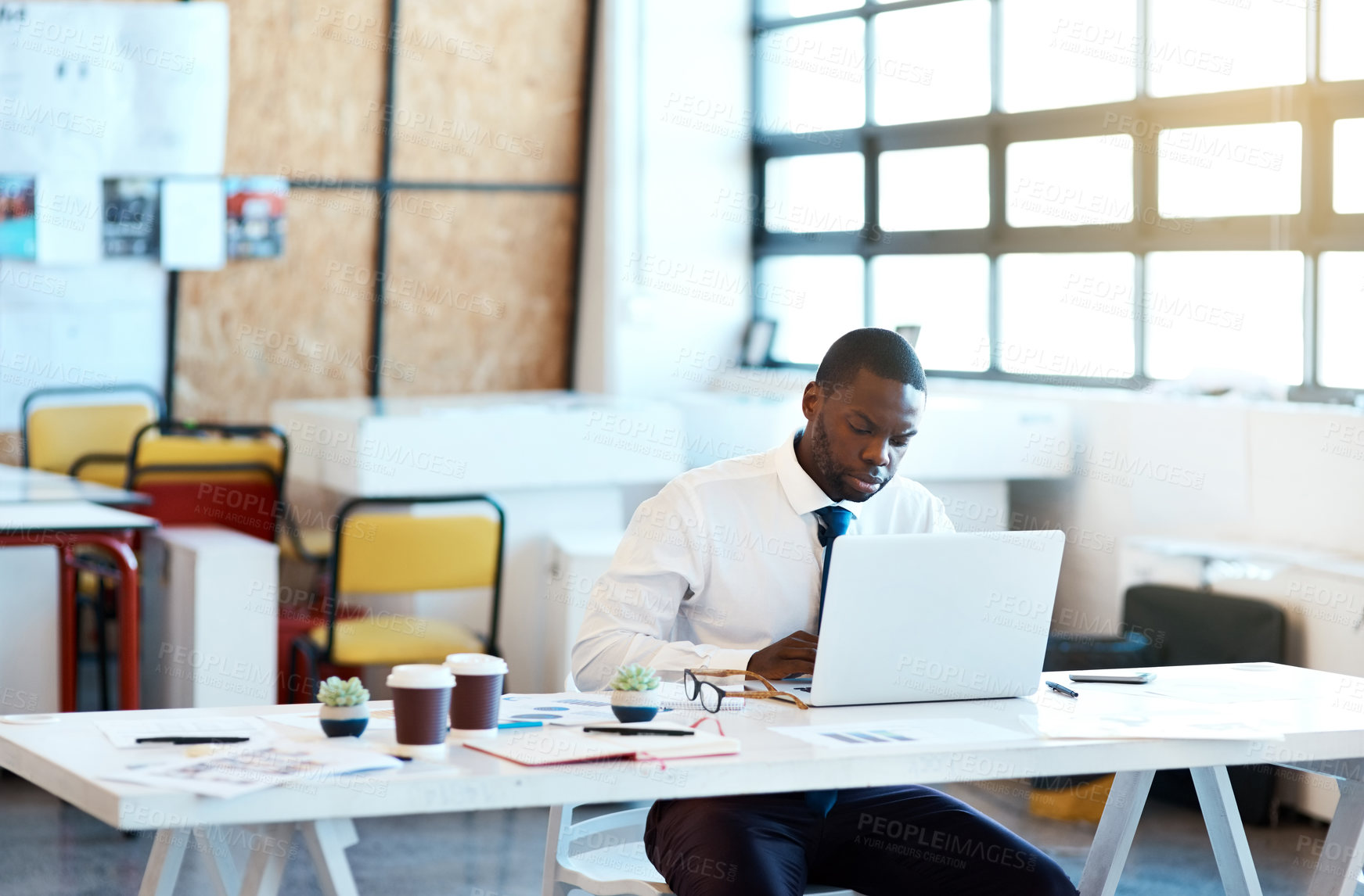 Buy stock photo African man, working and laptop as management, employee and accountant in finance company. Male person, tech and serious with email, project and portfolio for tax review, development or sales revenue