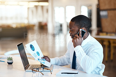 Buy stock photo Shot of an unrecognizable businessman talking on a cellphone while looking at a graph at work during the day