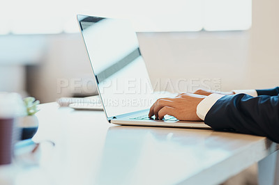 Buy stock photo Closeup of an unrecognizable businessman typing and working on a laptop in the office at work