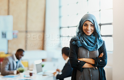 Buy stock photo Portrait of a confident young businesswoman standing in the office with her arms folded inside of the office at work