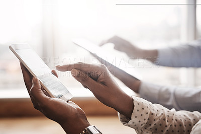 Buy stock photo Closeup shot of two unrecognisable businesspeople using digital devices in an office