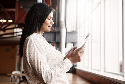 Buy stock photo Shot of a mature businesswoman using a digital tablet in an office