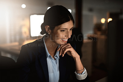 Buy stock photo Shot of a young businesswoman working online during a late night in a modern office