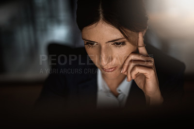 Buy stock photo Shot of a young businesswoman working online during a late night in a modern office