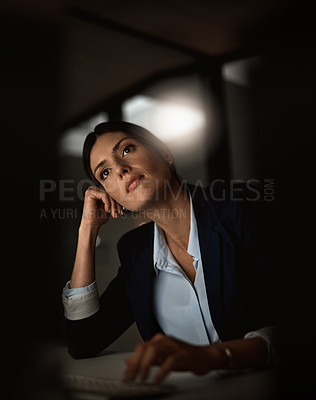 Buy stock photo Shot of a young businesswoman looking thoughtful during a late night in a modern office