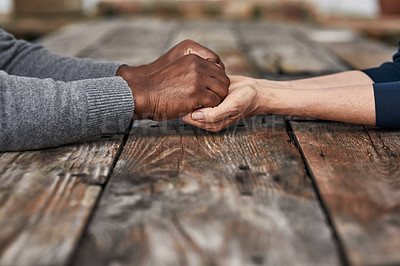 Buy stock photo Holding hands, love and support of people, table and kindness of empathy with respect, care and outdoor. Praying, compassion and patience of unity of couple, together and commitment of marriage