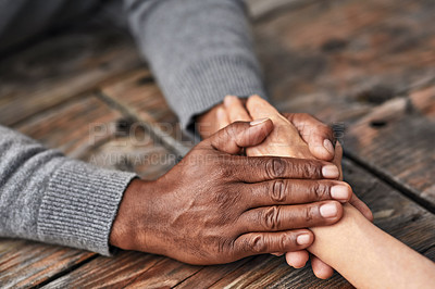 Buy stock photo High angle shot of an unrecognizable senior couple holding hands in comfort outside