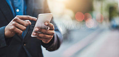 Buy stock photo Closeup shot of an unrecognizable businessman using a cellphone in the city