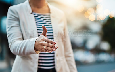 Buy stock photo Closeup shot of an unrecognizable businesswoman extending a handshake in the  city