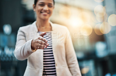 Buy stock photo Closeup shot of a young businesswoman extending a handshake in the  city