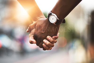 Buy stock photo Cropped shot of an affectionate couple holding hands outdoors