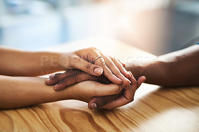 Buy stock photo Cropped shot of an unidentifiable man and woman holding hands on a table
