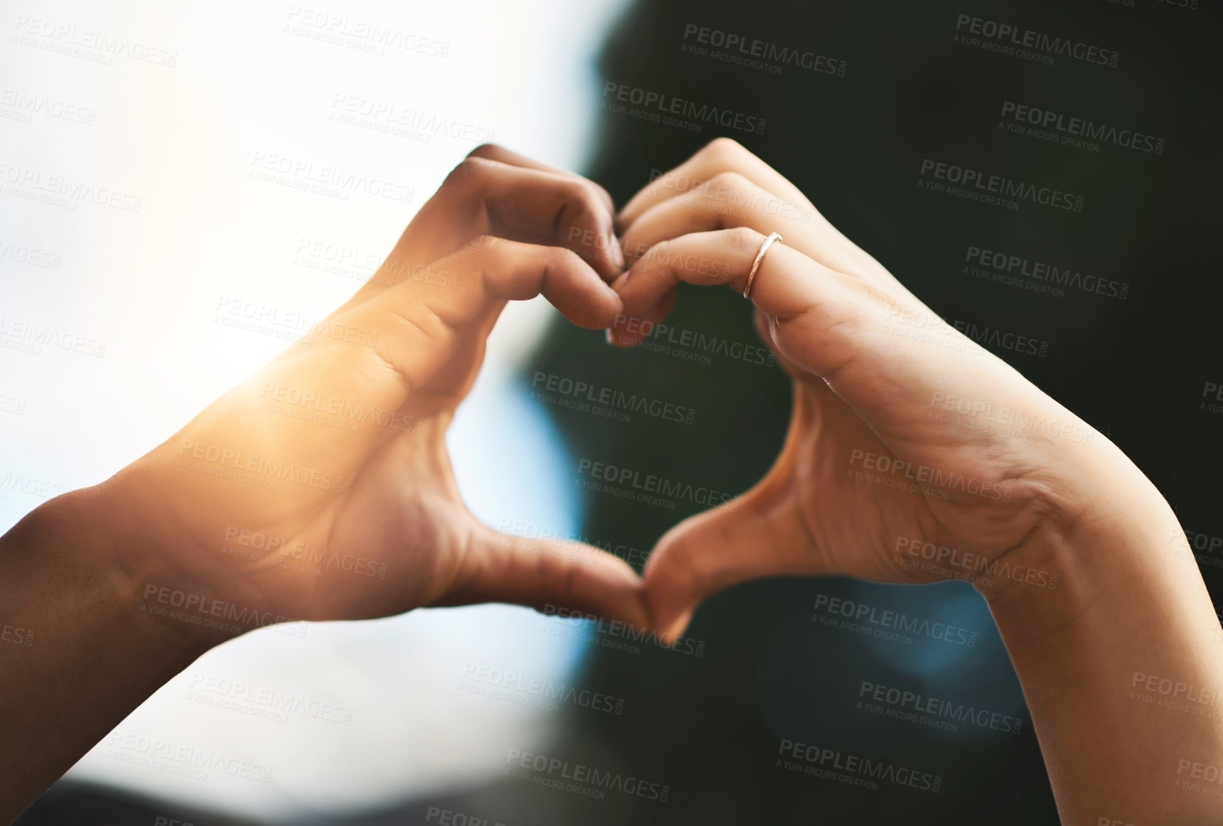 Buy stock photo Cropped shot of a couple making a heart gesture with their hands outdoors