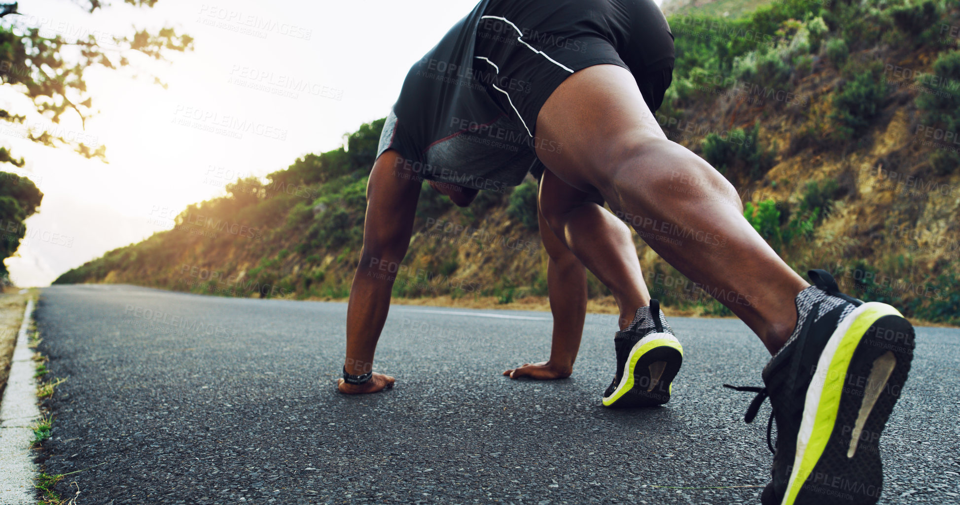 Buy stock photo Rearview shot of a sporty young man exercising outdoors