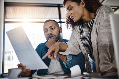 Buy stock photo Shot of a young couple planning their budget together at home