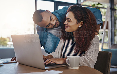 Buy stock photo Shot of a young couple planning their budget together on a laptop at home