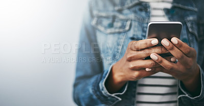 Buy stock photo Hands, cellphone and woman with texting by wall background with typing, mockup space or email on web. Student girl, smartphone and chat for blog, post or video on social network app for communication