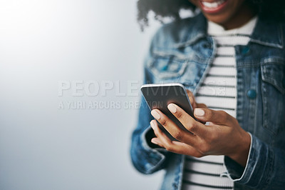 Buy stock photo Hands, cellphone and woman with typing by wall background with texting, mockup space or email on web. African girl, smartphone and chat for blog, post or video on social network app for connectivity