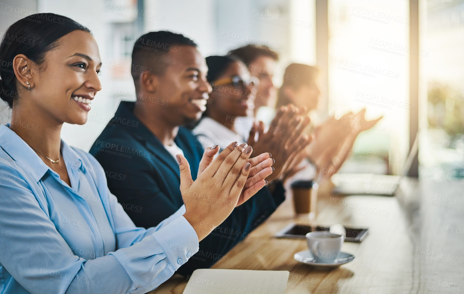 Buy stock photo Cropped shot of a group of young businesspeople applauding while sitting in the conference room during a seminar