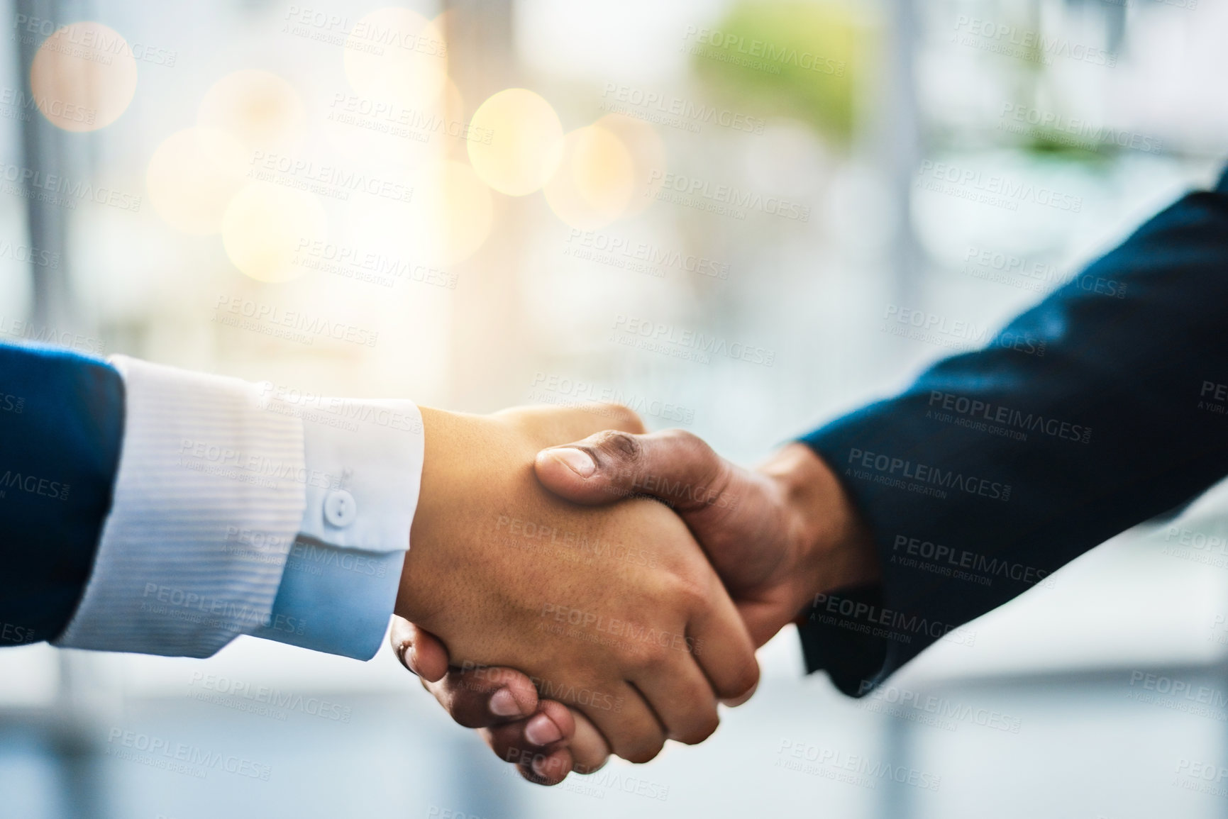 Buy stock photo Cropped shot of two unrecognizable businesspeople shaking hands while standing in their office