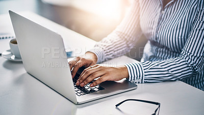 Buy stock photo Closeup shot of an unrecognizable businesswoman working on a laptop in an office