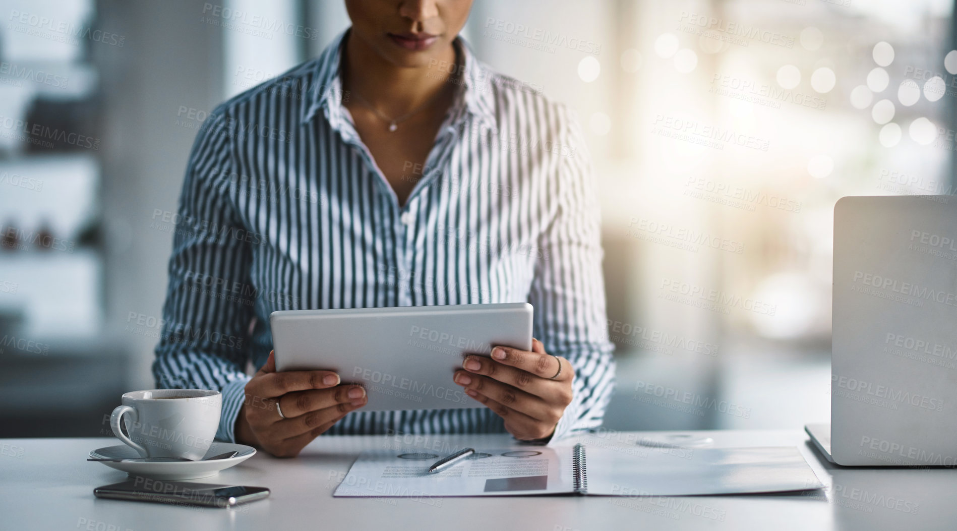 Buy stock photo Closeup shot of an unrecognizable businesswoman working on a digital tablet in an office