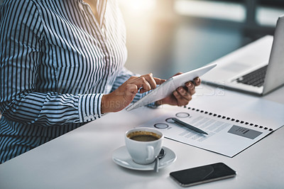 Buy stock photo Closeup shot of an unrecognizable businesswoman working on a digital tablet in an office