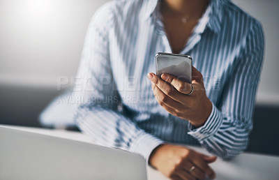 Buy stock photo Closeup shot of an unrecognizable businesswoman using a cellphone in an office