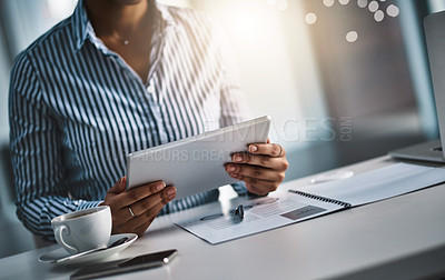 Buy stock photo Closeup shot of an unrecognizable businesswoman working on a digital tablet in an office