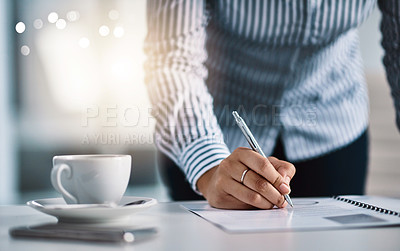 Buy stock photo Closeup shot of an unrecognizable businesswoman writing notes on a document in an office