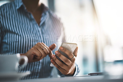 Buy stock photo Closeup shot of an unrecognizable businesswoman using a cellphone in an office