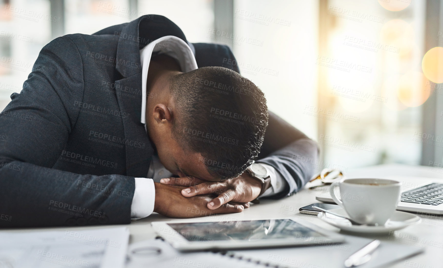 Buy stock photo Cropped shot of a young businessman sleeping at his desk after a long and tiring day