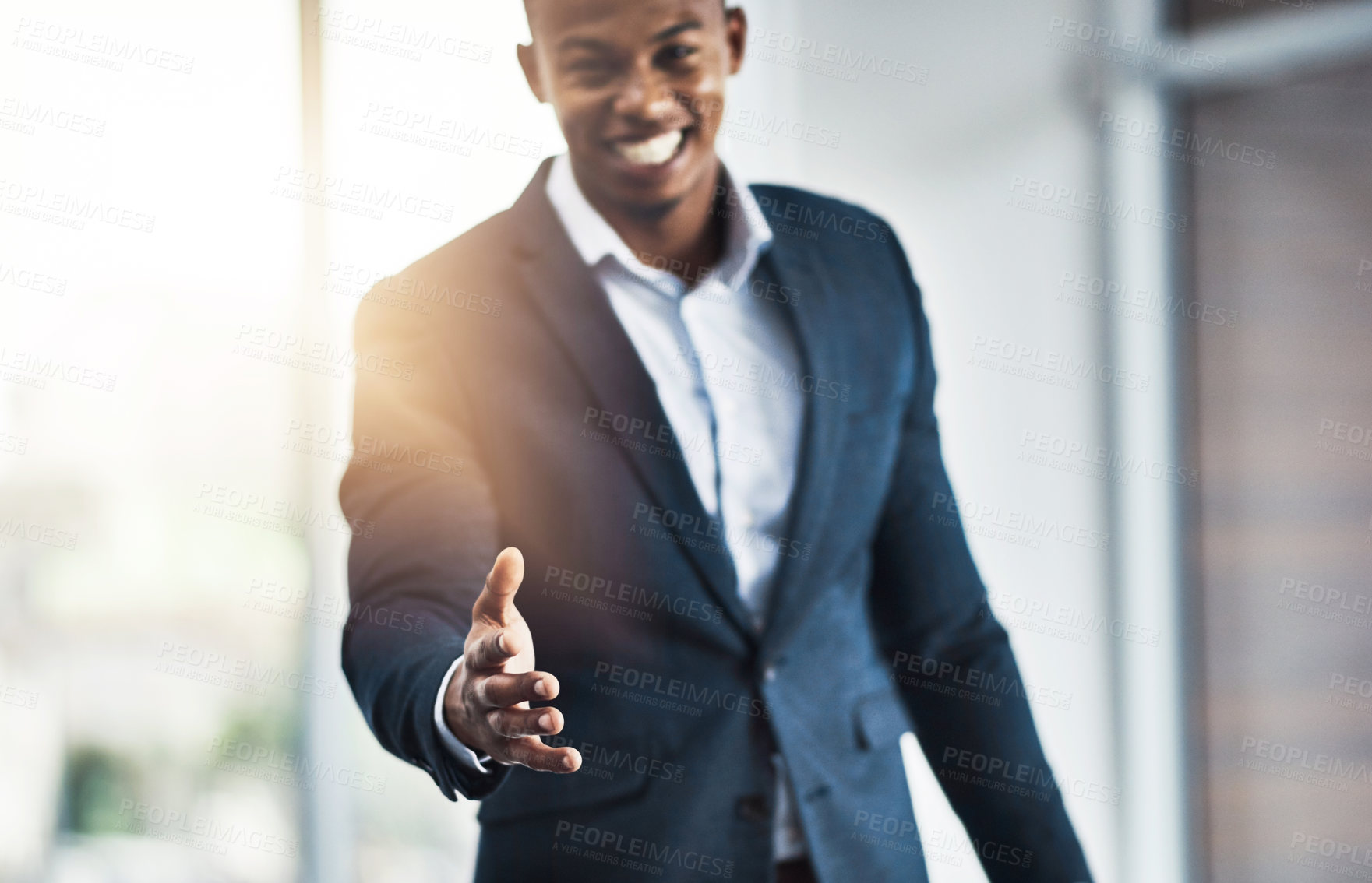 Buy stock photo Cropped portrait of a handsome young businessman offering his hand while standing in his modern office